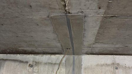Betondecke mit Riss und angeklebtem Gewebeband, freihängende Kabelenden