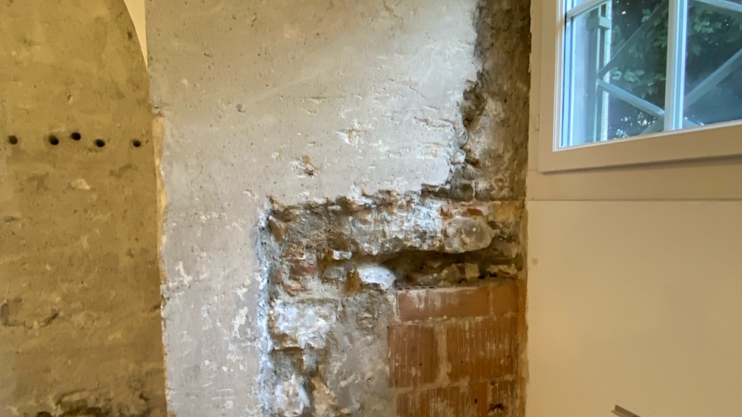 Freigelegtes beschädigtes Mauerwerk neben Fenster, Nahaufnahme