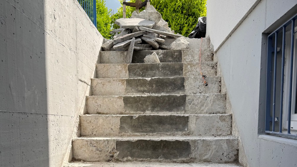 Betontreppe im Rohbau, oben liegen Betonbruch und Schutt.